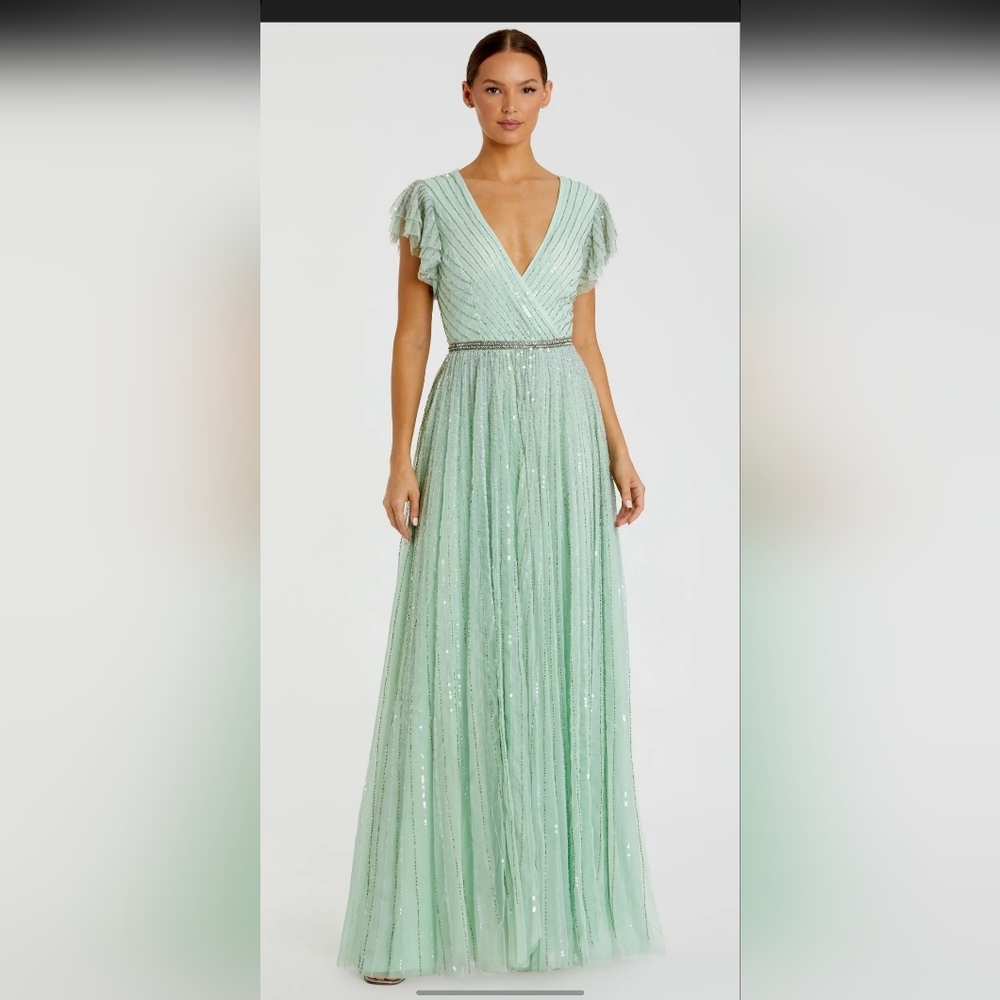 Green Sequined Wrap Over Ruffled Cap Sleeve Gown.